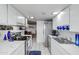 Bright kitchen design featuring stainless steel appliances, white cabinetry, and views into the connected living room at 3133 W Christy Dr, Phoenix, AZ 85029