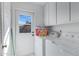 Clean laundry room with a side-by-side washer and dryer and white cabinets at 3133 W Christy Dr, Phoenix, AZ 85029