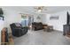 Cozy living area with soft carpet, ceiling fan, and sliding glass doors that bring the outdoor in at 3133 W Christy Dr, Phoenix, AZ 85029