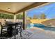 Inviting backyard patio with outdoor dining set and a beautiful view of the sparkling in-ground pool at 3238 W White Canyon Rd, San Tan Valley, AZ 85144