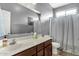 Well-lit bathroom with a large mirror, white countertops, and a shower-tub combo at 3238 W White Canyon Rd, San Tan Valley, AZ 85144