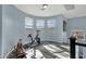 Bright bonus room featuring three windows, gray wood-look floors, and an exercise bike at 3238 W White Canyon Rd, San Tan Valley, AZ 85144