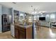 Open kitchen featuring stainless steel appliances, tile backsplash, and an island with a sink at 3238 W White Canyon Rd, San Tan Valley, AZ 85144