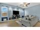 Cozy living room featuring a large television, recessed shelving, and comfortable gray couches at 3238 W White Canyon Rd, San Tan Valley, AZ 85144