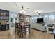 Spacious open-concept living room with dining area, wood accent wall, and comfortable seating at 3238 W White Canyon Rd, San Tan Valley, AZ 85144