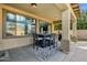 Covered outdoor patio with a dining table and chairs next to the pool at 3238 W White Canyon Rd, San Tan Valley, AZ 85144