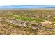 Wide aerial perspective showcasing a desert home near a golf course with mountain views and surrounding desert landscape at 33389 N 71St St, Scottsdale, AZ 85262