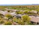 Overhead shot of a beautiful desert home featuring solar panels, desert landscape, and nearby golf course at 33389 N 71St St, Scottsdale, AZ 85262