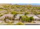 A stunning aerial shot of the house, complete with desert landscaping and a tan roof at 33389 N 71St St, Scottsdale, AZ 85262