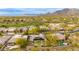 Beautiful aerial view capturing a desert home with a backyard pool, solar panels, and lush desert landscape at 33389 N 71St St, Scottsdale, AZ 85262