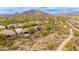 Scenic overhead shot capturing a desert home with solar panels, a desert landscape, and a mountain backdrop at 33389 N 71St St, Scottsdale, AZ 85262