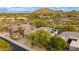 Aerial view of home and community featuring desert landscape, mountain views, and solar panels at 33389 N 71St St, Scottsdale, AZ 85262