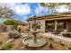 Backyard showcasing fountain, pond, solar panels, and covered patio with seating - perfect for outdoor enjoyment at 33389 N 71St St, Scottsdale, AZ 85262