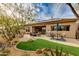 Inviting backyard with desert landscaping, artificial grass, solar panels, and a spacious patio ideal for outdoor living at 33389 N 71St St, Scottsdale, AZ 85262