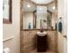 Small powder room featuring a decorative framed mirror and pedestal sink with dark wood cabinetry at 33389 N 71St St, Scottsdale, AZ 85262