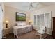 Neutral-toned guest bedroom with plantation shutters and ceiling fan at 33389 N 71St St, Scottsdale, AZ 85262