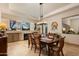 Dining room featuring travertine floors, a fireplace, and a view to the backyard at 33389 N 71St St, Scottsdale, AZ 85262