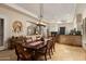 Elegant dining room features a stylish chandelier and seamless flow to kitchen bar at 33389 N 71St St, Scottsdale, AZ 85262