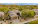 Charming single-story home featuring desert landscaping and solar panels on the roof at 33389 N 71St St, Scottsdale, AZ 85262