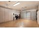 Spacious garage with ample storage cabinets, bright lighting, and an automatic door opener at 33389 N 71St St, Scottsdale, AZ 85262