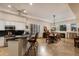 Open kitchen and dining area with white cabinetry, granite countertops, and travertine flooring at 33389 N 71St St, Scottsdale, AZ 85262