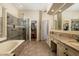 Bright main bathroom with double vanity, bathtub, and glass shower at 33389 N 71St St, Scottsdale, AZ 85262