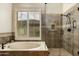 Beautiful bathroom featuring a luxurious soaking tub and a tiled glass shower at 33389 N 71St St, Scottsdale, AZ 85262