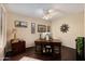 A home office featuring a hardwood floor, decorative ceiling fan and dark wood furniture at 33389 N 71St St, Scottsdale, AZ 85262