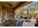 Covered patio with a ceiling fan, dining area, and comfortable seating, creating an inviting outdoor living space at 33389 N 71St St, Scottsdale, AZ 85262