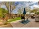 Comfortable patio with outdoor dining and barbecue area surrounded by lush desert landscaping and an artificial grass accent at 33389 N 71St St, Scottsdale, AZ 85262