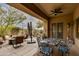 Inviting covered patio featuring multiple seating areas, offering a perfect blend of comfort and desert views at 33389 N 71St St, Scottsdale, AZ 85262