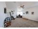 Large carpeted room with a ceiling fan and a desk set up near the window at 3482 N 300Th Dr, Buckeye, AZ 85396