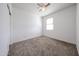 Carpeted bedroom with a ceiling fan and a window allowing natural light to illuminate the space at 3482 N 300Th Dr, Buckeye, AZ 85396