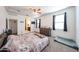 Spacious bedroom featuring neutral carpet, a ceiling fan, and a view of the en suite bathroom at 3482 N 300Th Dr, Buckeye, AZ 85396