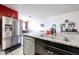 Stylish kitchen featuring stainless steel appliances, granite countertops, and a view into the dining area at 3482 N 300Th Dr, Buckeye, AZ 85396