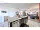 Open-concept kitchen island with granite countertops and stainless steel dishwasher flows into the living room at 3482 N 300Th Dr, Buckeye, AZ 85396