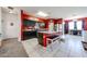 Modern kitchen with granite counters, black cabinets, a center island, and tiled floors at 3482 N 300Th Dr, Buckeye, AZ 85396