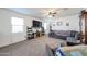 Bright and spacious living room featuring carpet flooring and a comfortable seating area at 3482 N 300Th Dr, Buckeye, AZ 85396