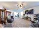 Cozy living room with a television, adjacent to a kitchen with an island and appliances at 3482 N 300Th Dr, Buckeye, AZ 85396