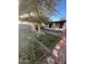 Backyard with a shed, grassy lawn, stone accents, and mature tree at 3527 W Almeria Rd, Phoenix, AZ 85009