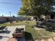 Lush backyard featuring mature trees, a mix of gravel and turf, and a brick-paved patio area at 3527 W Almeria Rd, Phoenix, AZ 85009