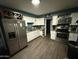 Kitchen with white cabinets, stainless steel appliances, and wood look flooring at 3527 W Almeria Rd, Phoenix, AZ 85009