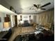 Living room featuring wood-look flooring, a ceiling fan and decorative accents at 3527 W Almeria Rd, Phoenix, AZ 85009