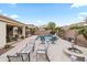 Beautiful backyard pool with a water feature, grill, firepit, covered patio and mature landscaping perfect for entertaining at 4272 E Ivanhoe St, Gilbert, AZ 85295