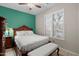 Bedroom featuring window with plantation shutters, decorative bed frame and matching bench at 4272 E Ivanhoe St, Gilbert, AZ 85295