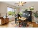 Cozy dining room with a large window overlooking a patio and lush backyard landscaping at 4272 E Ivanhoe St, Gilbert, AZ 85295