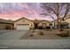 Charming single-story home with a two-car garage and desert landscaping at sunset at 4272 E Ivanhoe St, Gilbert, AZ 85295