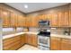 Well-lit kitchen featuring stainless steel appliances and ample wooden cabinetry at 4272 E Ivanhoe St, Gilbert, AZ 85295