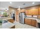 Bright kitchen featuring stainless steel appliances, tile countertops, and warm wood cabinets at 4272 E Ivanhoe St, Gilbert, AZ 85295