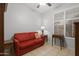 Neutral living room with a bright red sofa, end tables and tile floors at 4272 E Ivanhoe St, Gilbert, AZ 85295